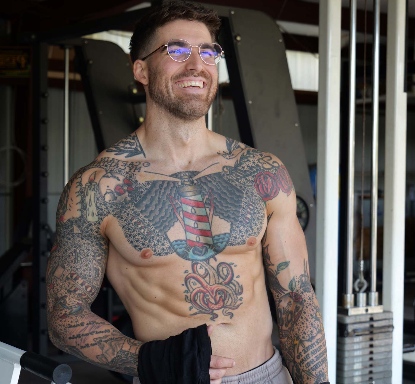 A picture of the smiling coaches showcasing his body